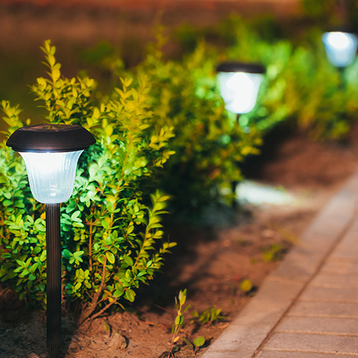 Stone patio illuminated with outdoor lighting system